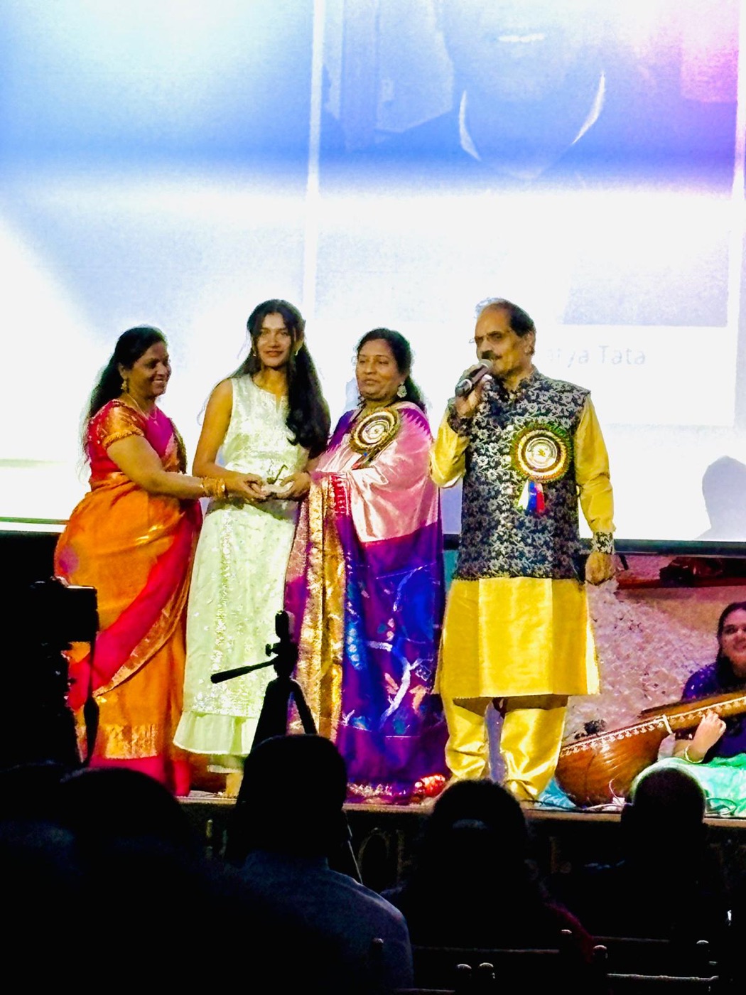 Sharanya honored on stage at a Telugu cultural program